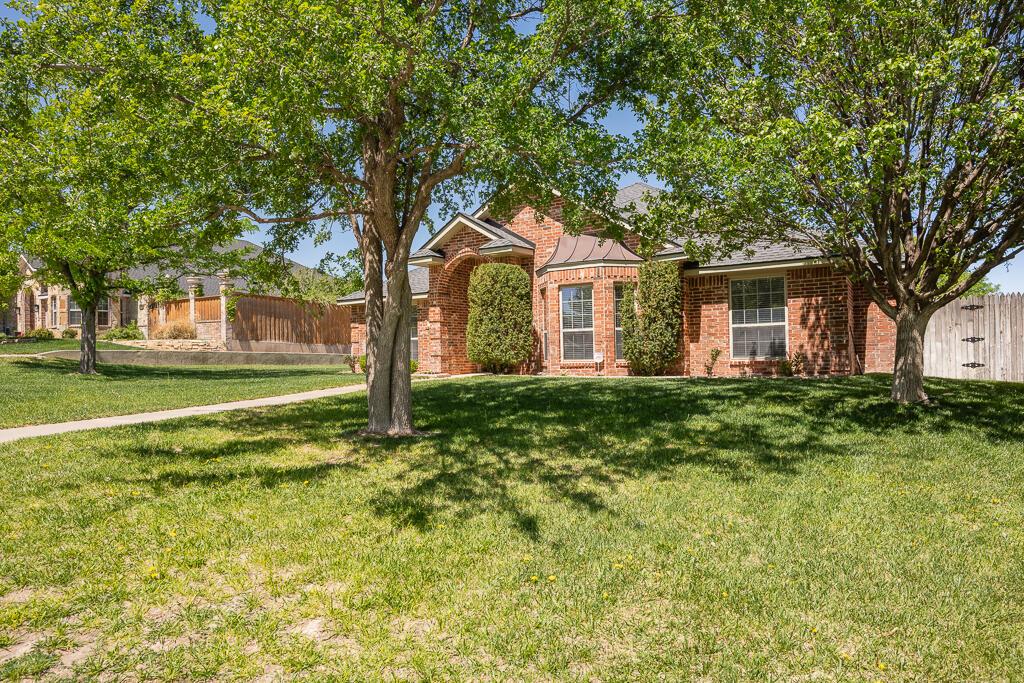 6604 Pepper Tree Place Amarillo, TX 79124 - Photo 4 of 28 a front view of a house with a yard
