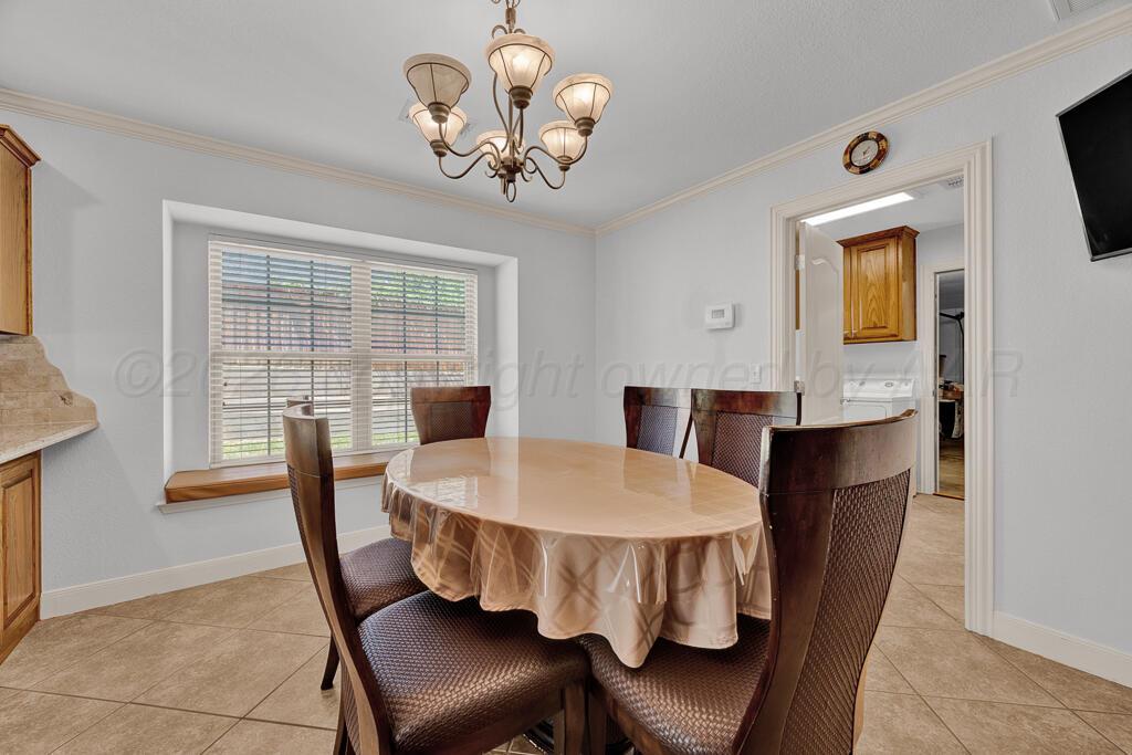 6604 Pepper Tree Place Amarillo, TX 79124 - Photo 10 of 28 a view of a dining room with furniture window and wooden floor