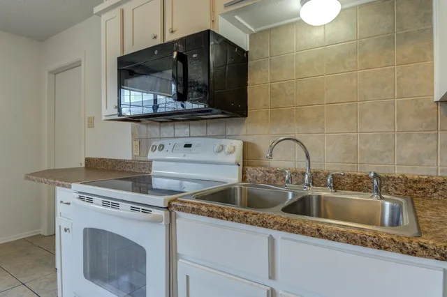 a close view of a sink and a stove in a kitchen