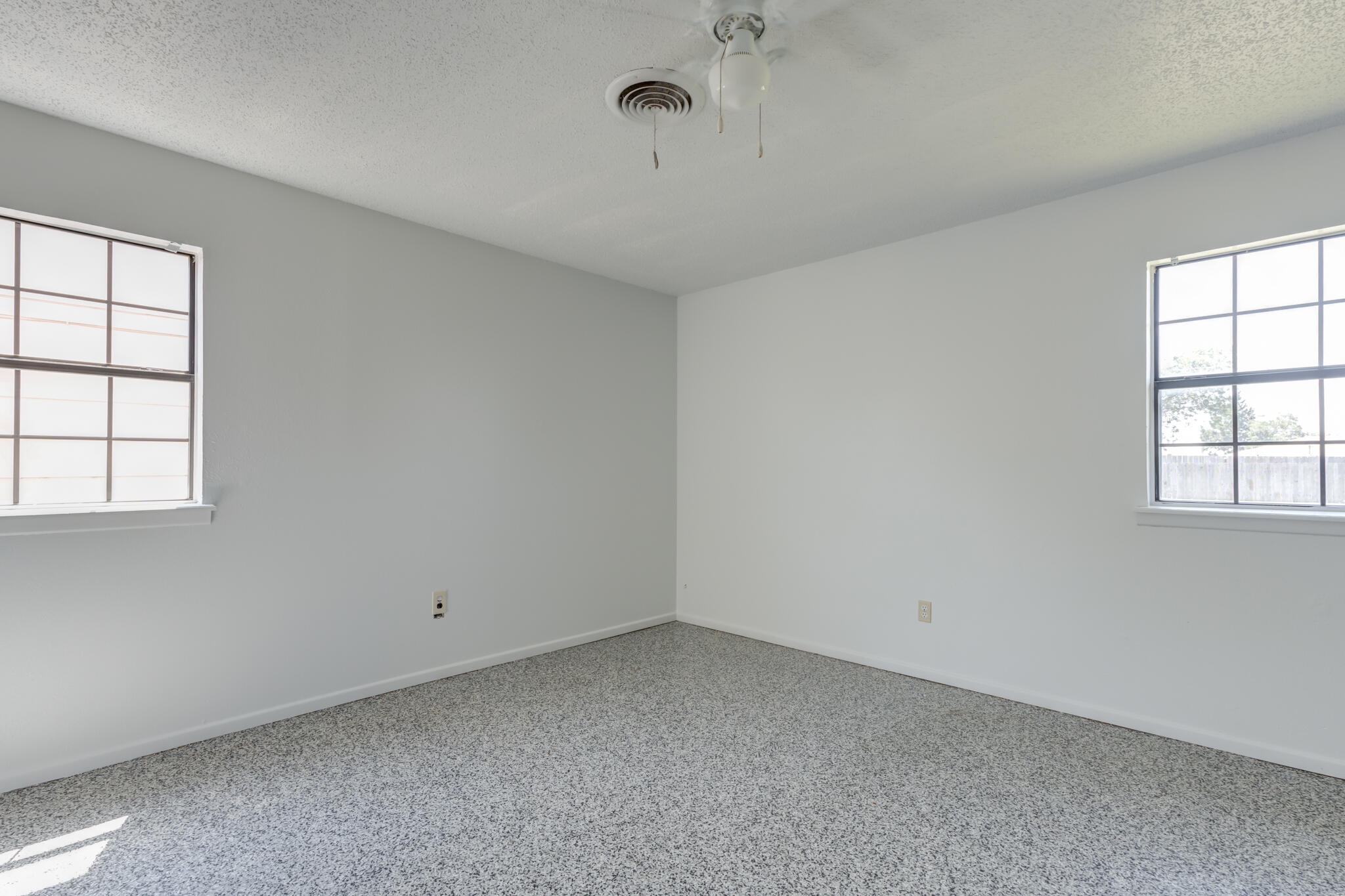 1313 Adrian Street Lubbock, TX 79403 - Photo 16 of 26 an empty room with windows