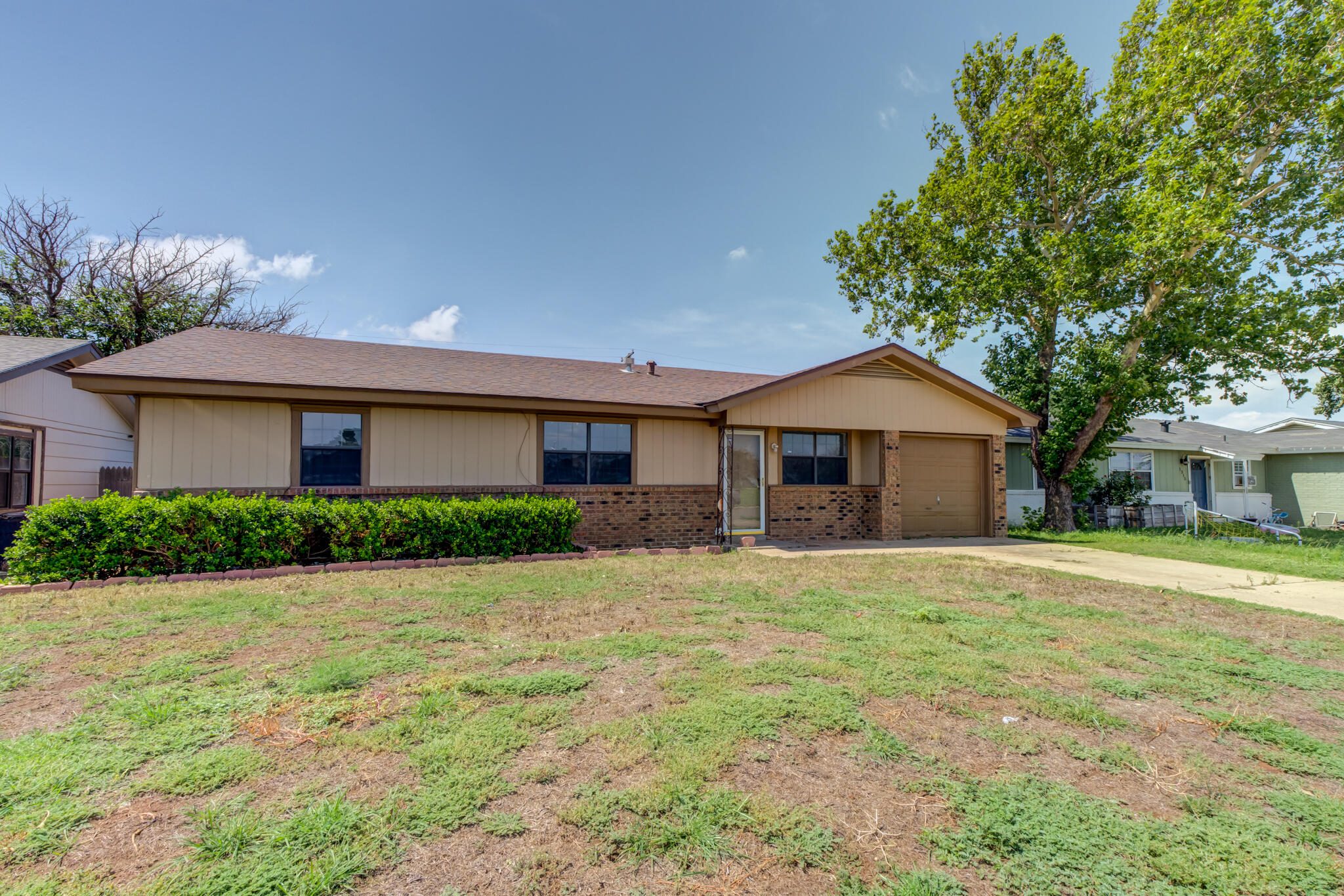 1313 Adrian Street Lubbock, TX 79403 - Photo 3 of 26 a front view of house with yard and trees