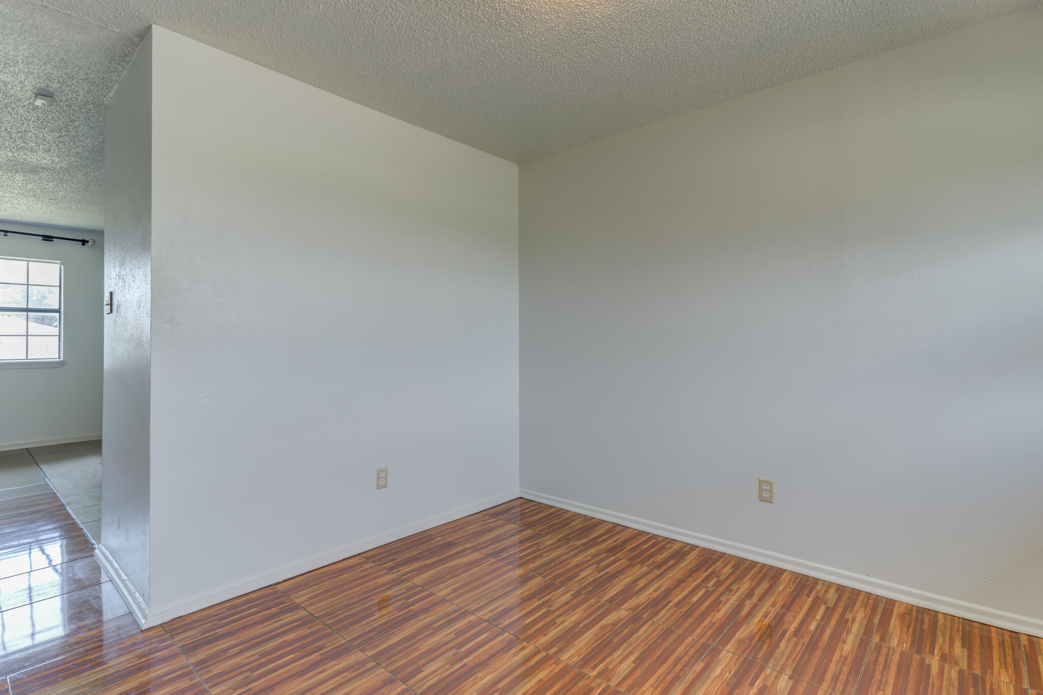 1313 Adrian Street Lubbock, TX 79403 - Photo 4 of 26 a view of a room with wooden floor