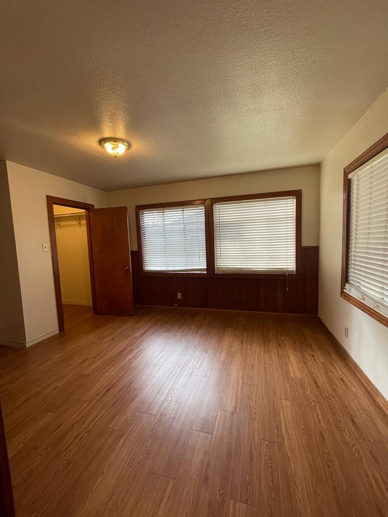 108 Austin Street, Unit B Kyle, TX 78640 - Photo 14 of 14 A versatile room with durable laminate flooring and warm wood accents awaits your personal touch.