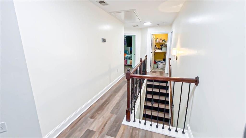 3281 Alhambra Circle Hampton, GA 30228 - Photo 35 of 88 a view of a hallway with wooden floor and staircase