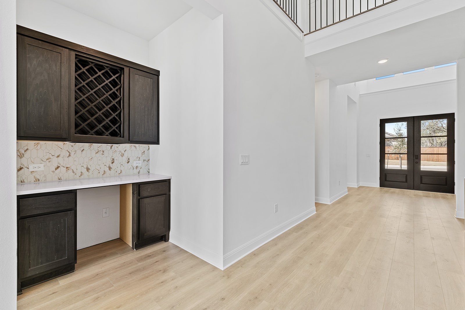 304 Barnstorm Lane Georgetown, TX 78633 - Photo 5 of 40 a view of a kitchen with a sink and dishwasher with wooden floor