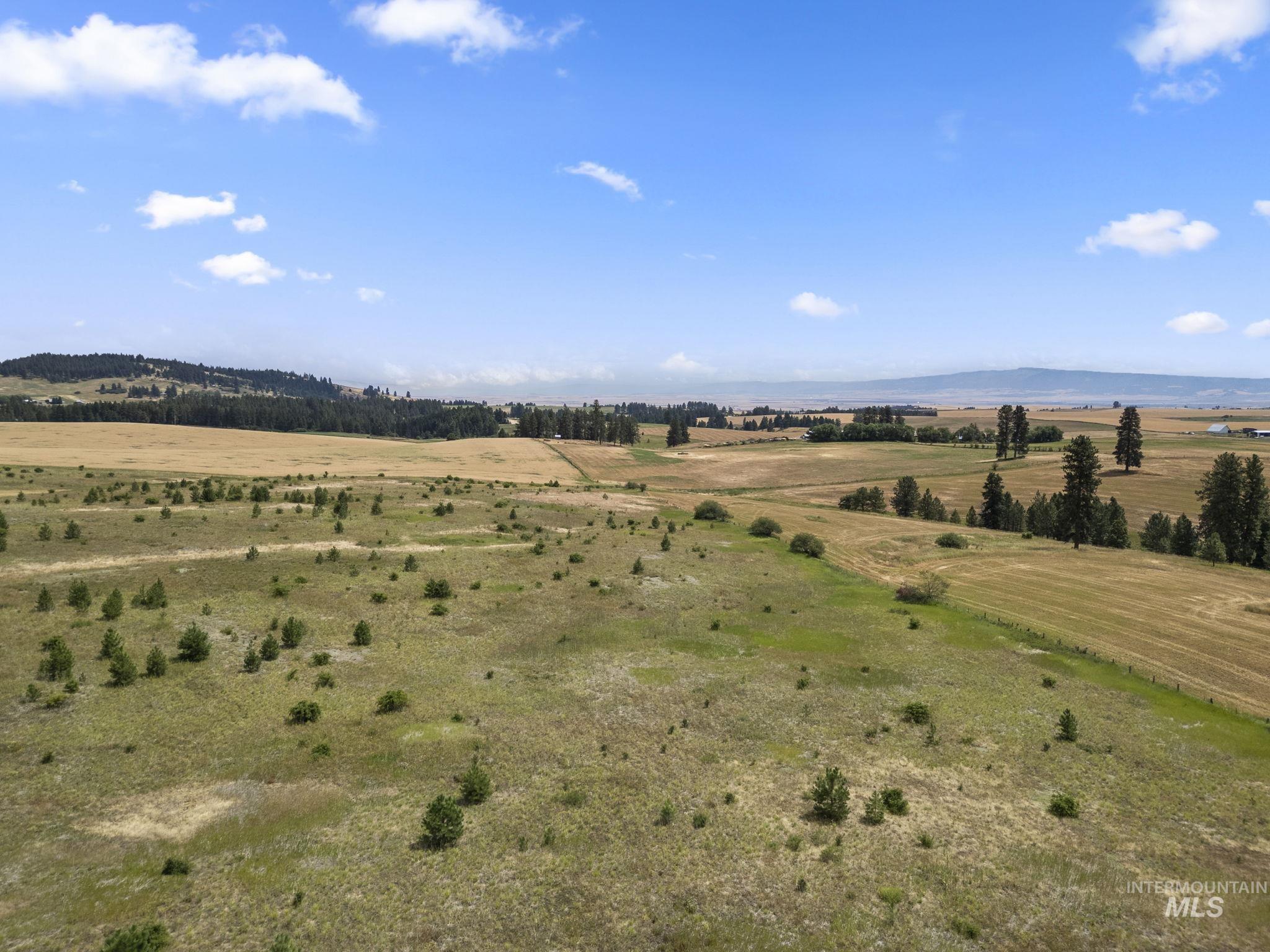View of mountain backdrop with rural landscape