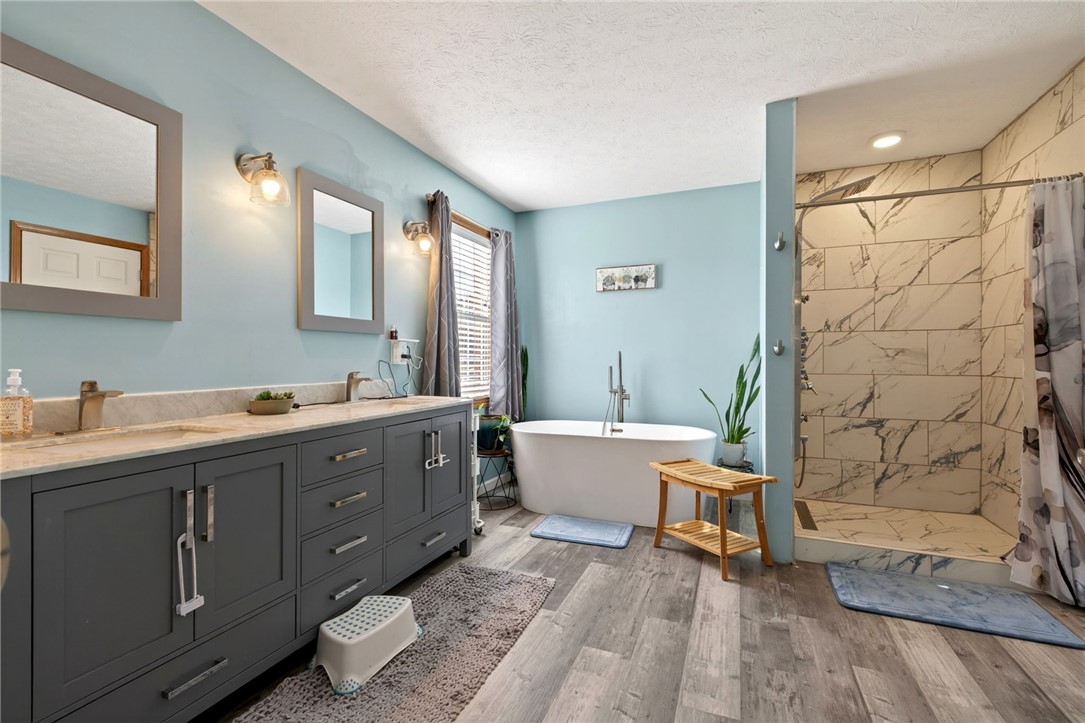 4996 Shannon Avenue Springfield, OH 45504 - Photo 7 of 61 This bathroom features a double vanity, a soaking tub, and a separate shower, creating a serene retreat.
