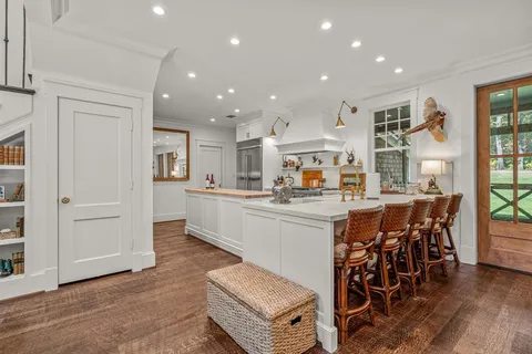 a kitchen with stainless steel appliances kitchen island granite countertop a table and chairs in it