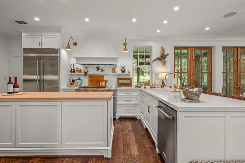 a kitchen with counter top space and windows