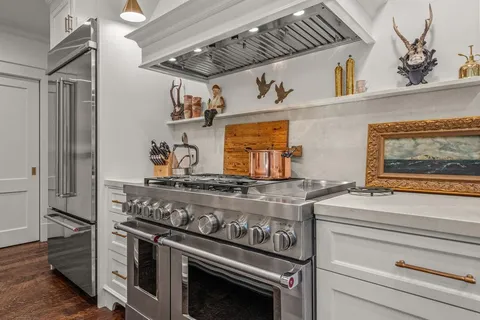 a stove top oven sitting inside of a kitchen
