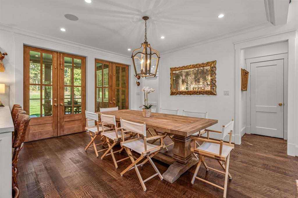 877 Private Road 7893 Mineola, TX 75773 - Photo 20 of 40 a dining room with wooden floor a chandelier a wooden table and chairs