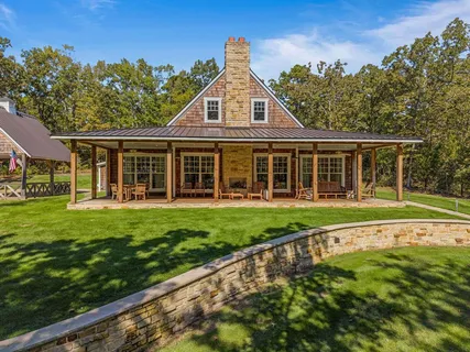 a view of a house with a yard and sitting area