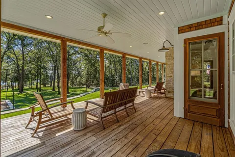 a view of a patio with wooden floor and iron stairs