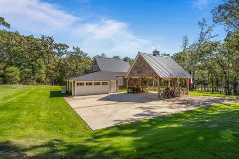 a front view of house with yard and green space