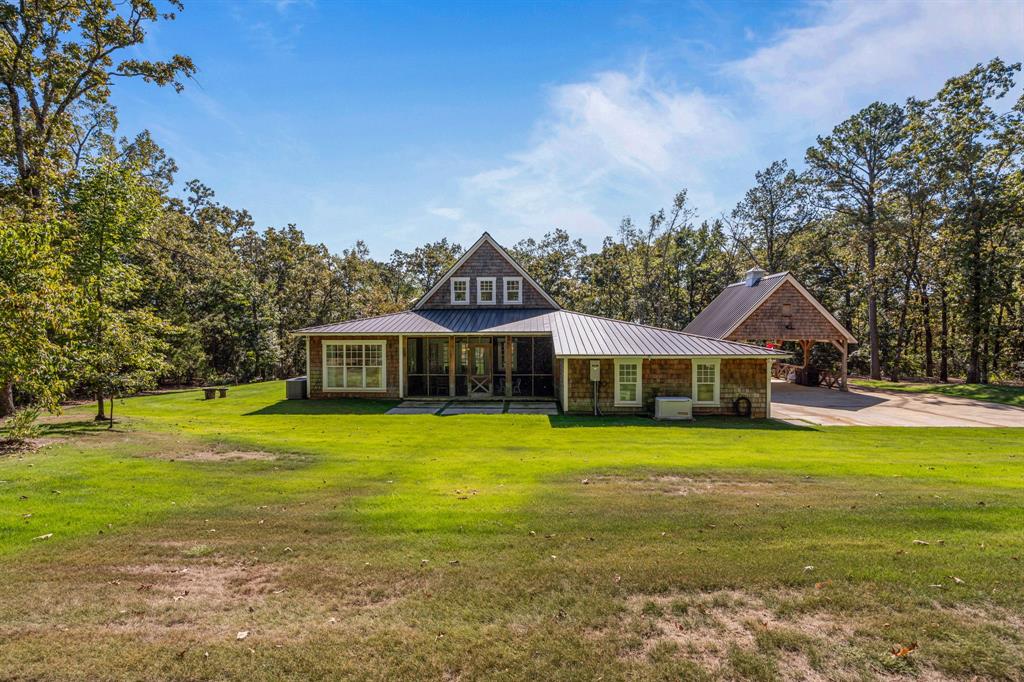 877 Private Road 7893 Mineola, TX 75773 - Photo 38 of 40 a front view of a house with a garden