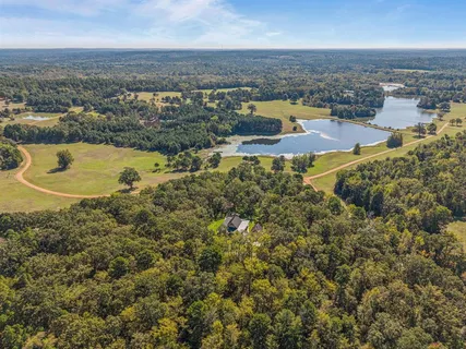 an aerial view of residential houses with outdoor space and swimming pool