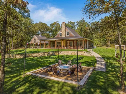a view of a house with backyard porch and sitting area