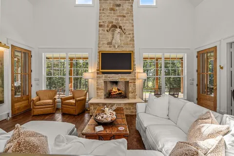 a living room with furniture large window and a fireplace