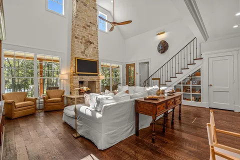 a living room with fireplace furniture and a flat screen tv