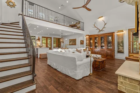 a living room with furniture wooden floor and ceiling fan