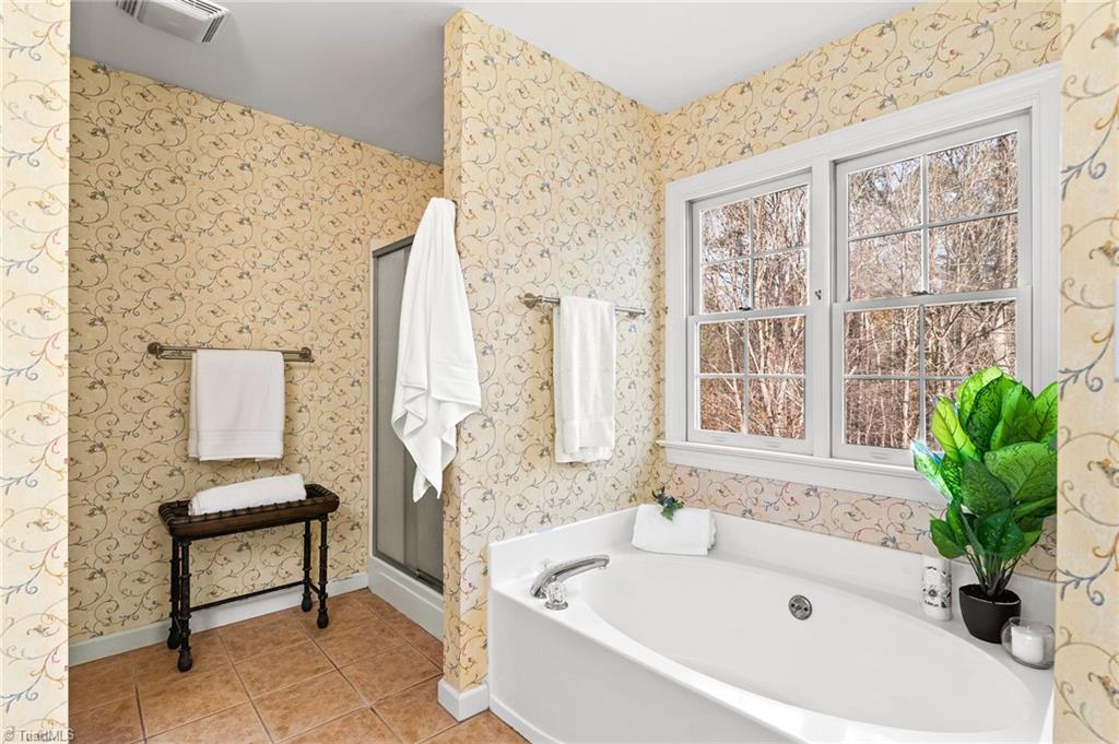2505 Burch Point High Point, NC 27265 - Photo 21 of 39 Master bathroom boasts a spacious garden tub and separate shower! Check out the private feeling of the wooded back views!