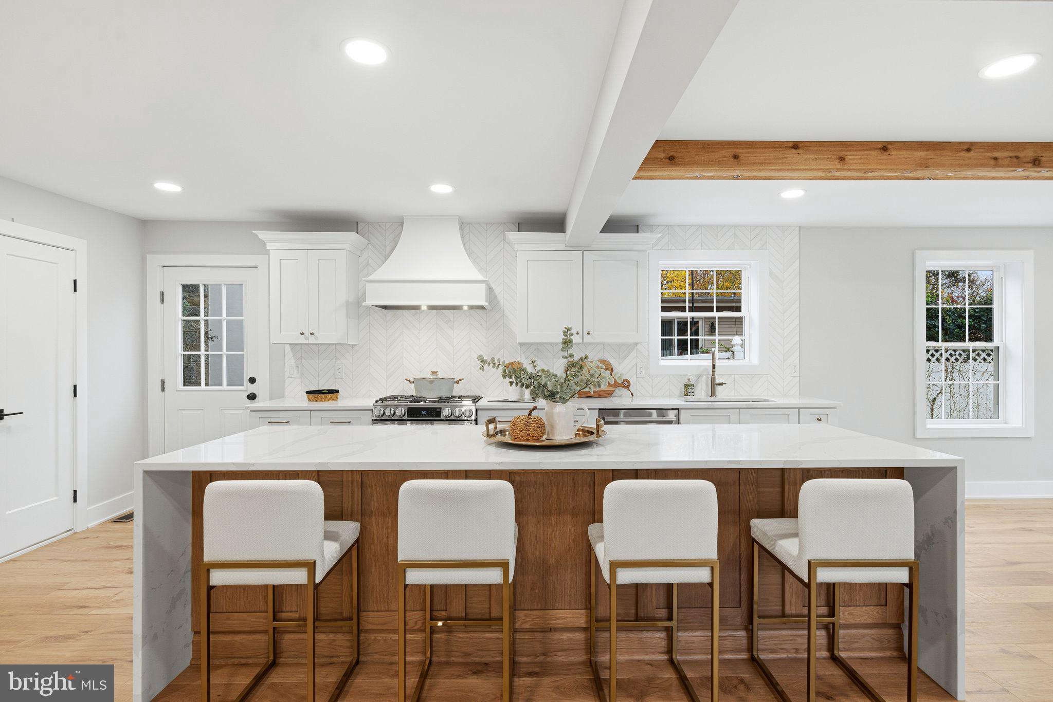 428 Mansfield Avenue Haddonfield, NJ 08033 - Photo 11 of 37 a kitchen with stainless steel appliances granite countertop a table chairs sink and cabinets