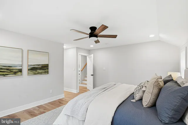 a bedroom with a bed and a painting on the wall