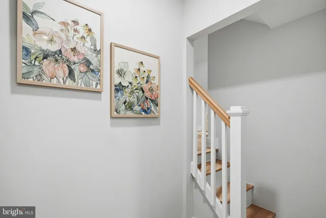 a view of a hallway with a painting on the wall