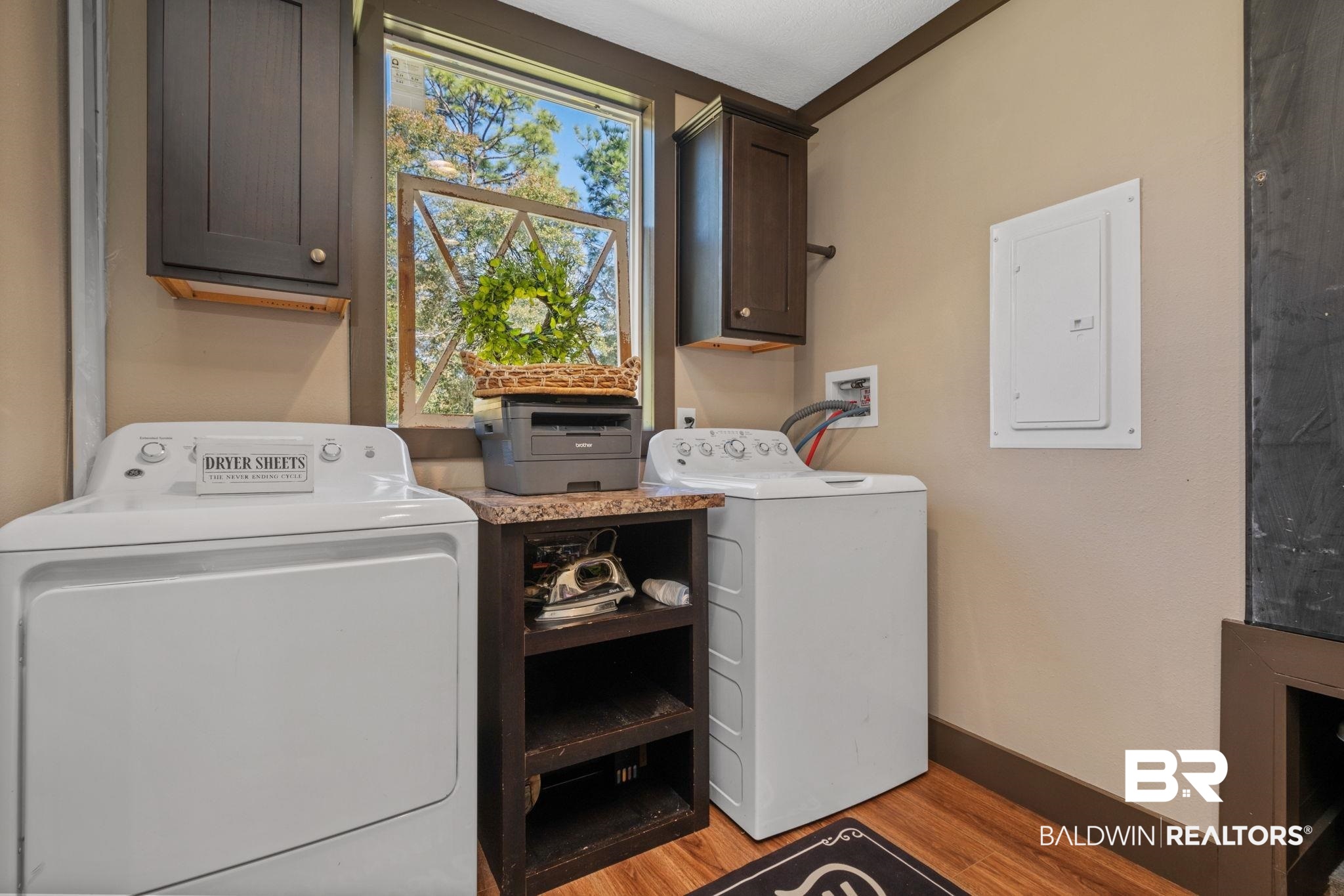 15080 Starlight Avenue Wilmer, AL 36587 - Photo 26 of 29 Clothes washing area featuring cabinets, washing machine and clothes dryer, electric panel, and light hardwood / wood-style flooring
