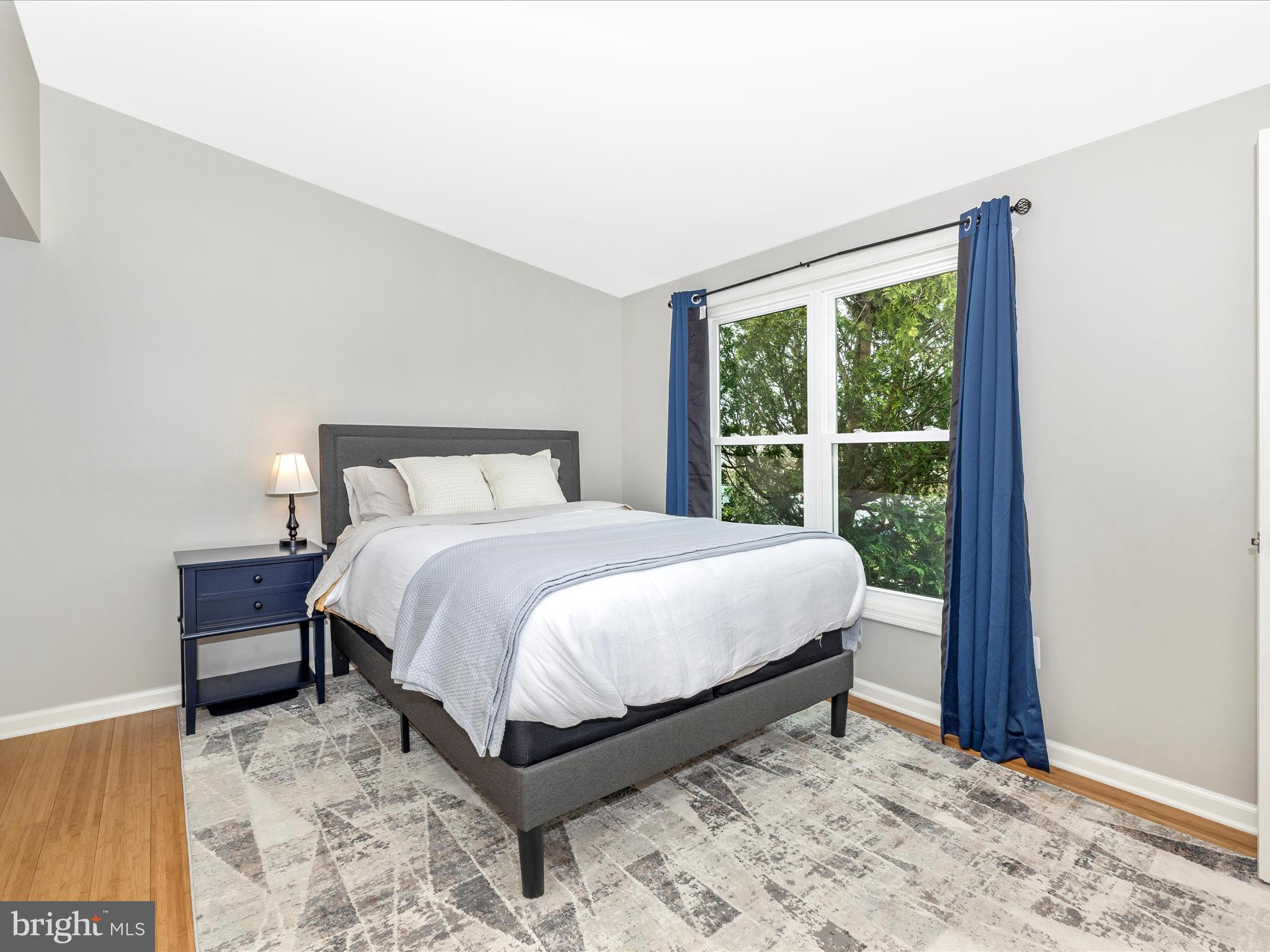 1127 Daffodil Drive Frederick, MD 21703 - Photo 25 of 61 a bedroom with a bed lamp and a large window
