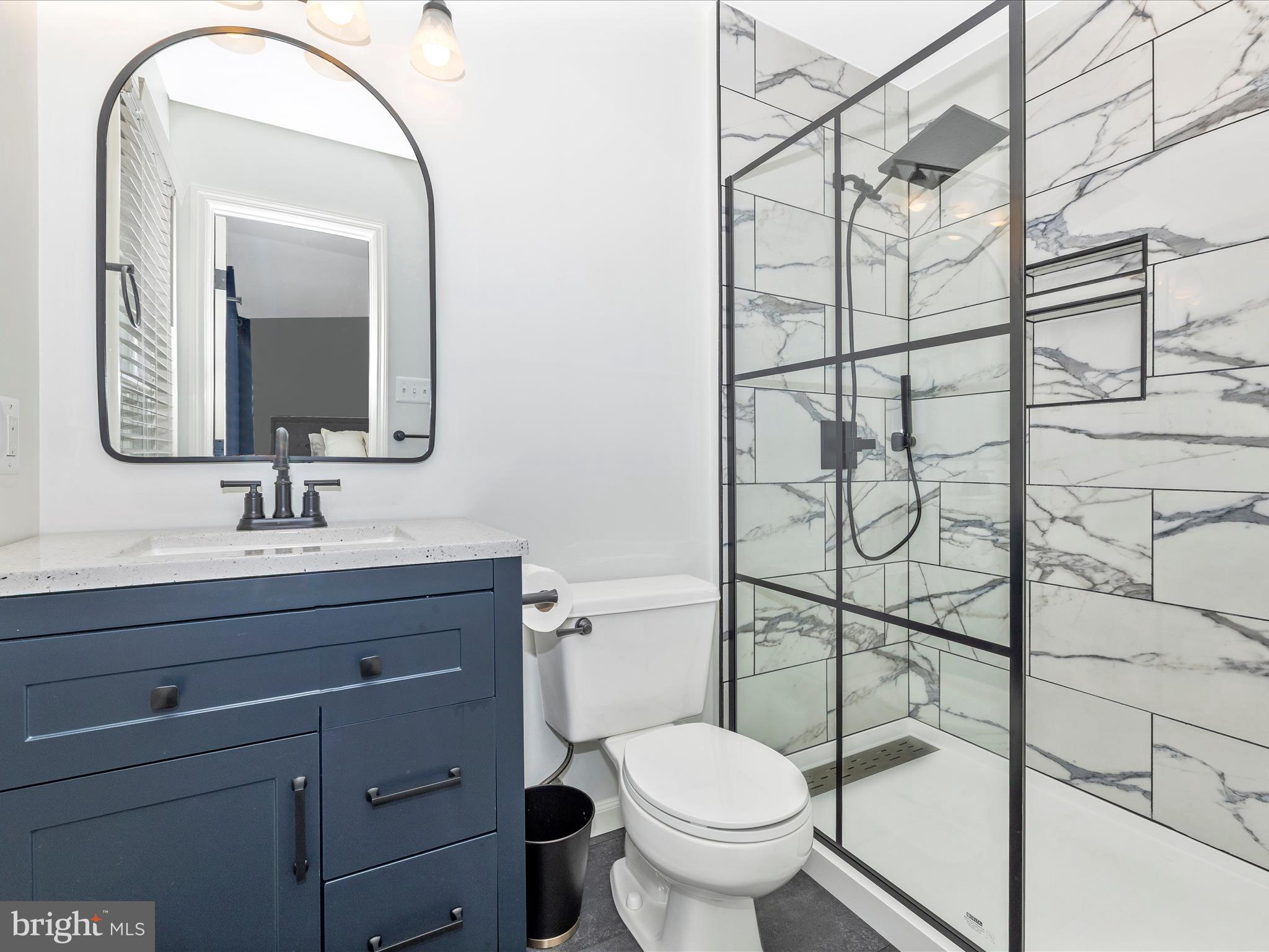 1127 Daffodil Drive Frederick, MD 21703 - Photo 29 of 61 a bathroom with a toilet sink vanity and mirror