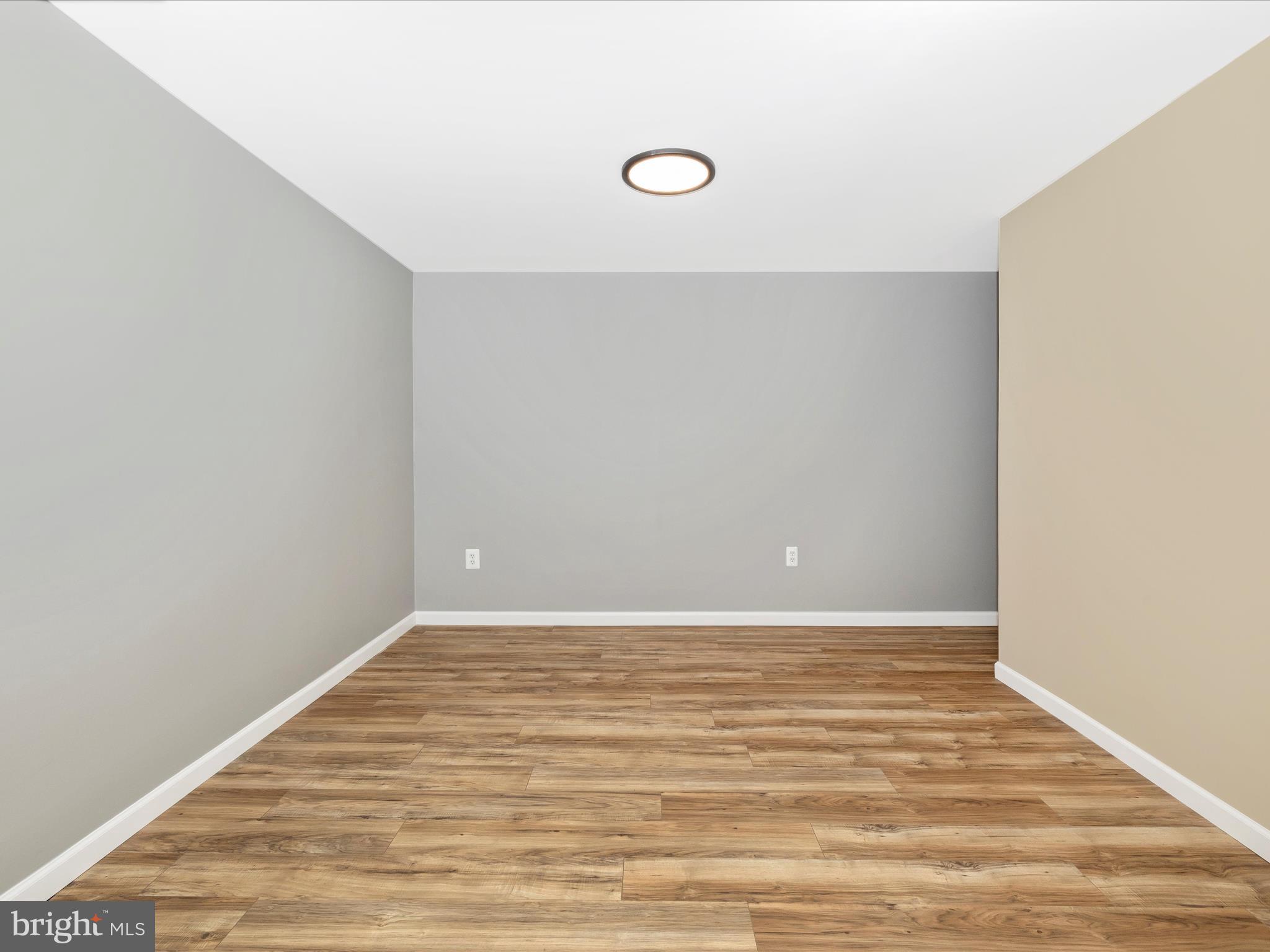 1127 Daffodil Drive Frederick, MD 21703 - Photo 38 of 61 a view of an empty room with wooden floor