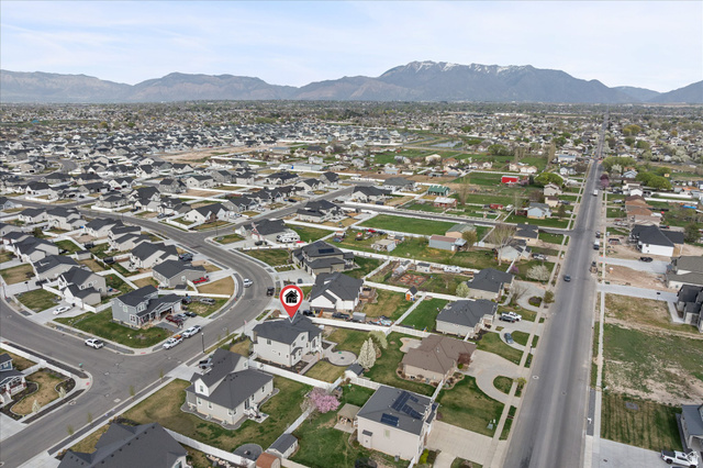 3359 Eurasian Crane Road Clinton, UT 84015 - Photo 59 of 71 Aerial overview of property's location with nearby suburban area and a mountainous background