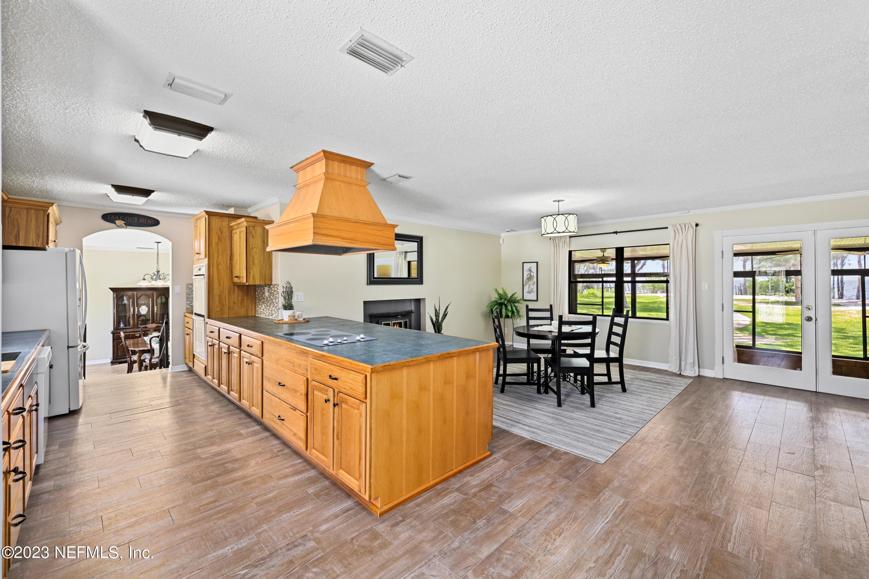 716 Cedar Creek Road Palatka, FL 32177 - Photo 12 of 62 a large kitchen with stainless steel appliances wooden floors and wooden cabinets