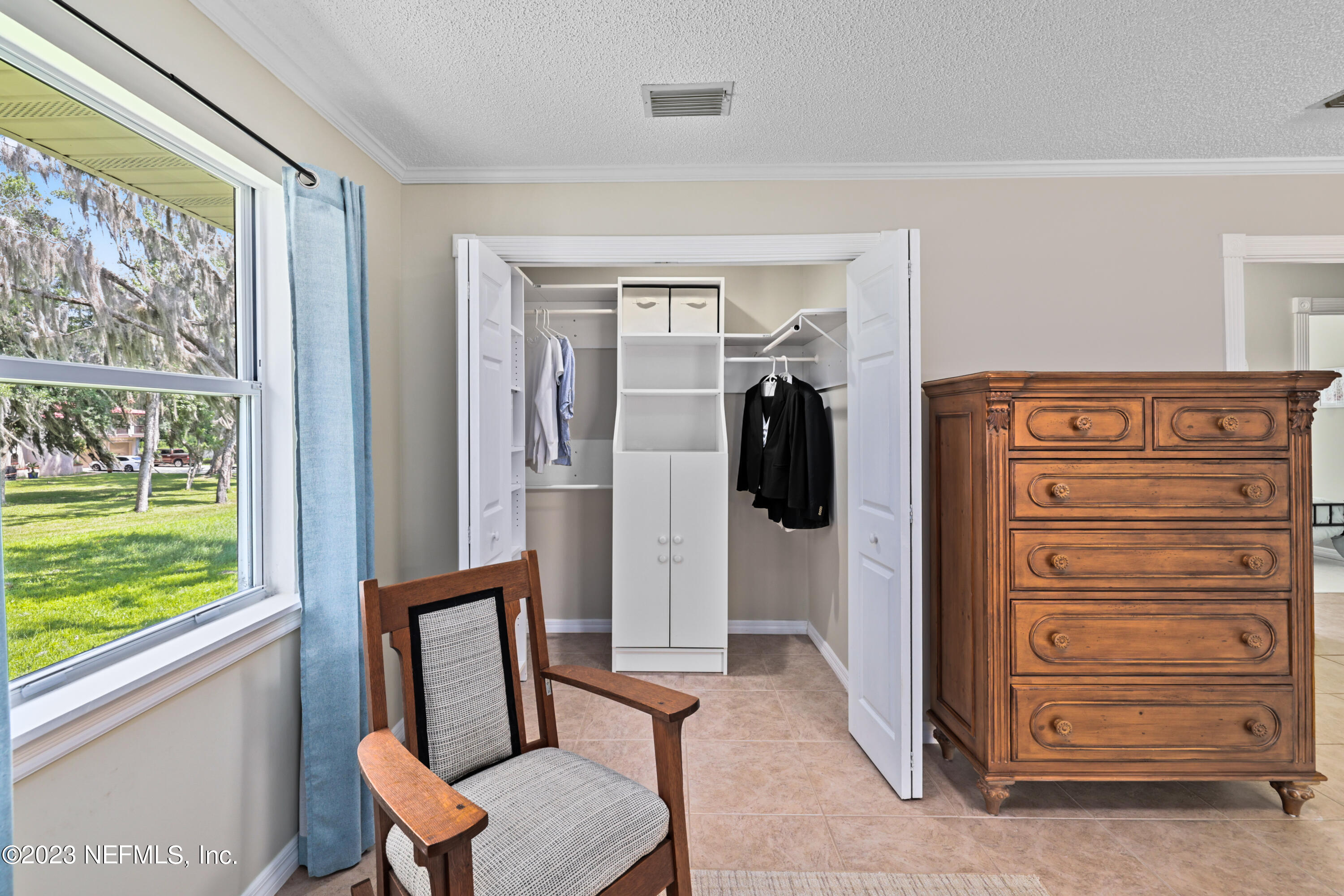 716 Cedar Creek Road Palatka, FL 32177 - Photo 31 of 62 a view of walk in closet with clothes and shoes