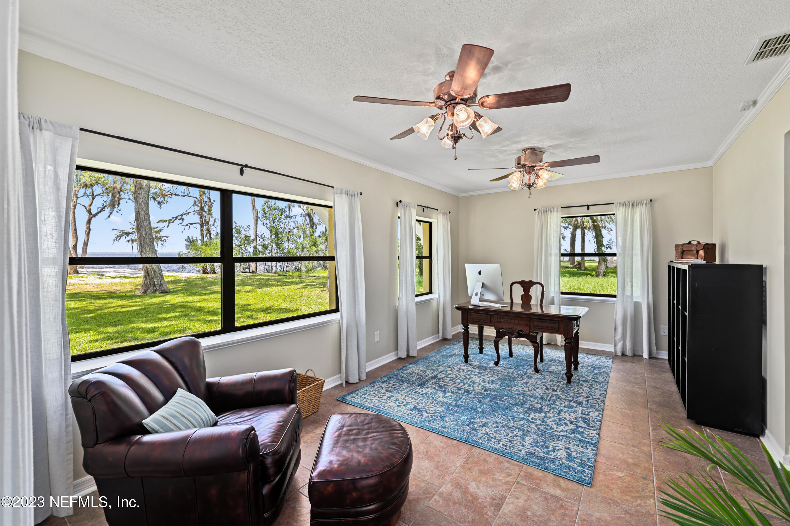 716 Cedar Creek Road Palatka, FL 32177 - Photo 44 of 62 a living room with furniture a table and a large window