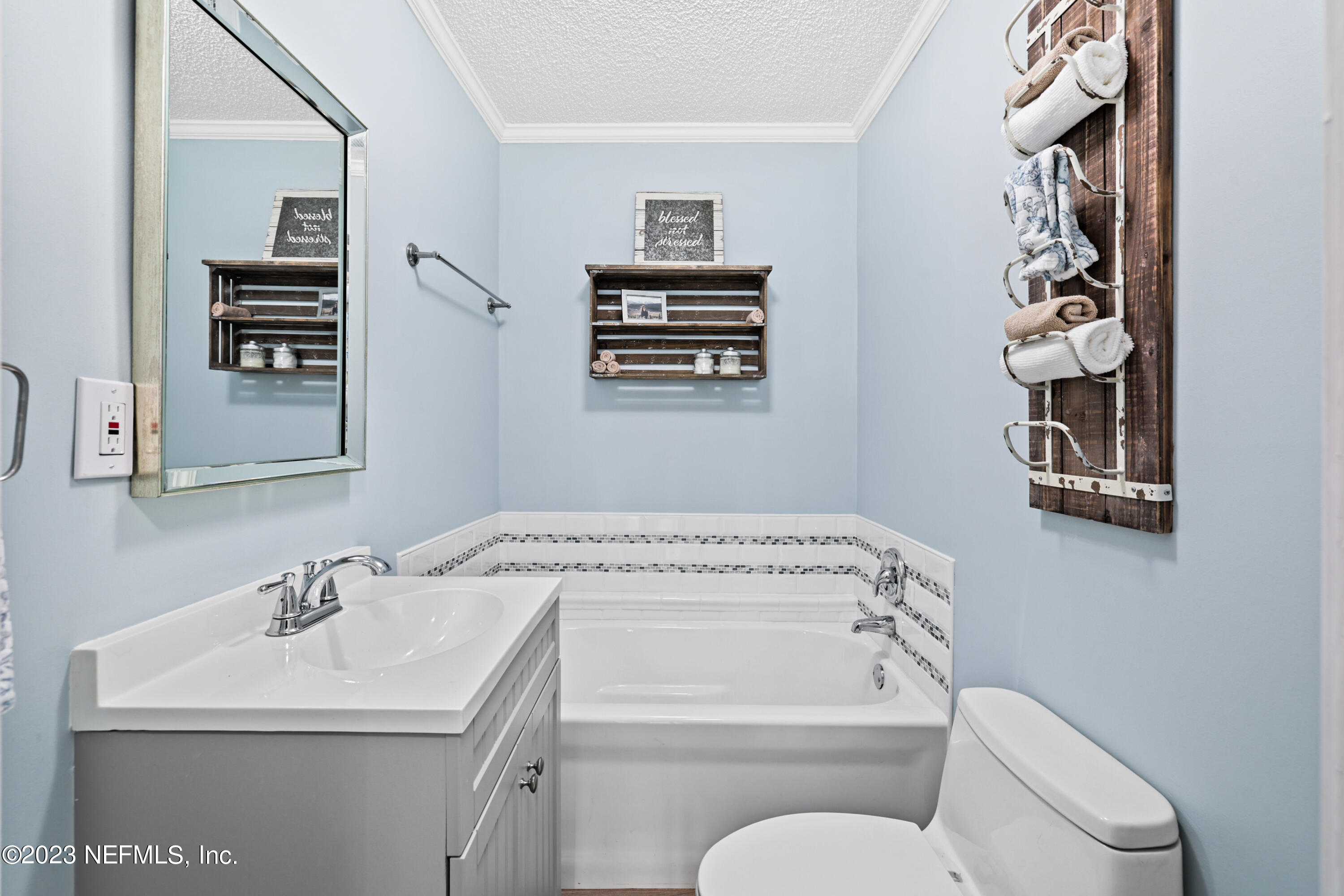 716 Cedar Creek Road Palatka, FL 32177 - Photo 48 of 62 a bathroom with a toilet a sink and a mirror