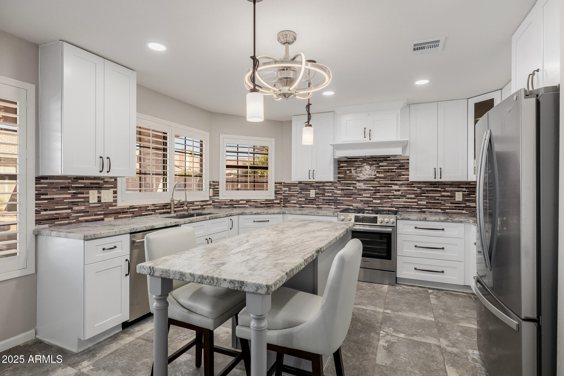 16809 South 33rd Way Phoenix, AZ 85048 - Photo 41 of 118 a kitchen with stainless steel appliances granite countertop a table chairs sink refrigerator and microwave