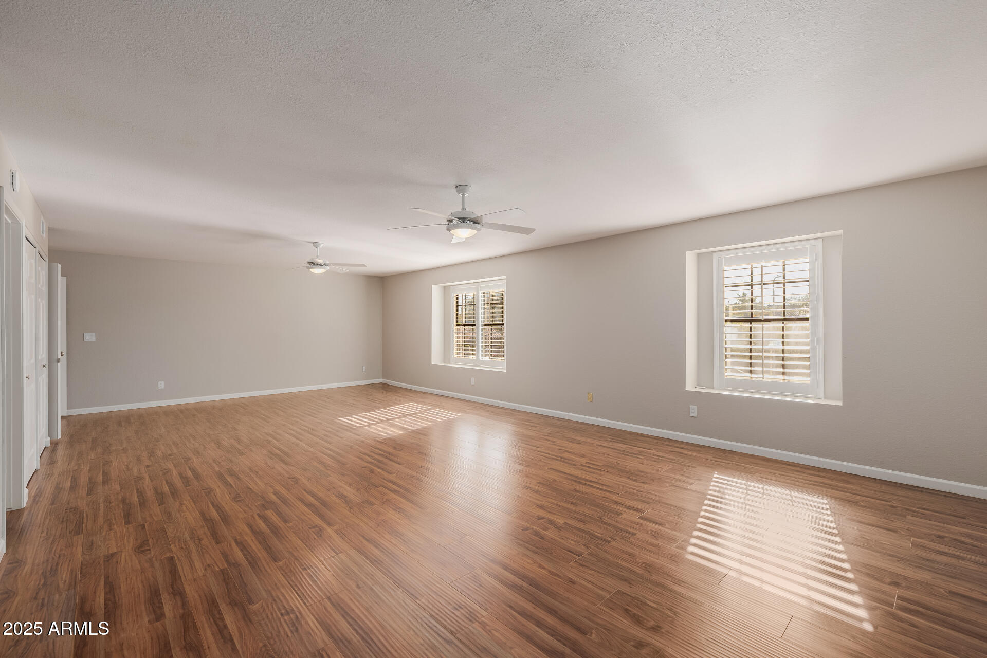 16809 South 33rd Way Phoenix, AZ 85048 - Photo 53 of 118 a view of an empty room with wooden floor and a window