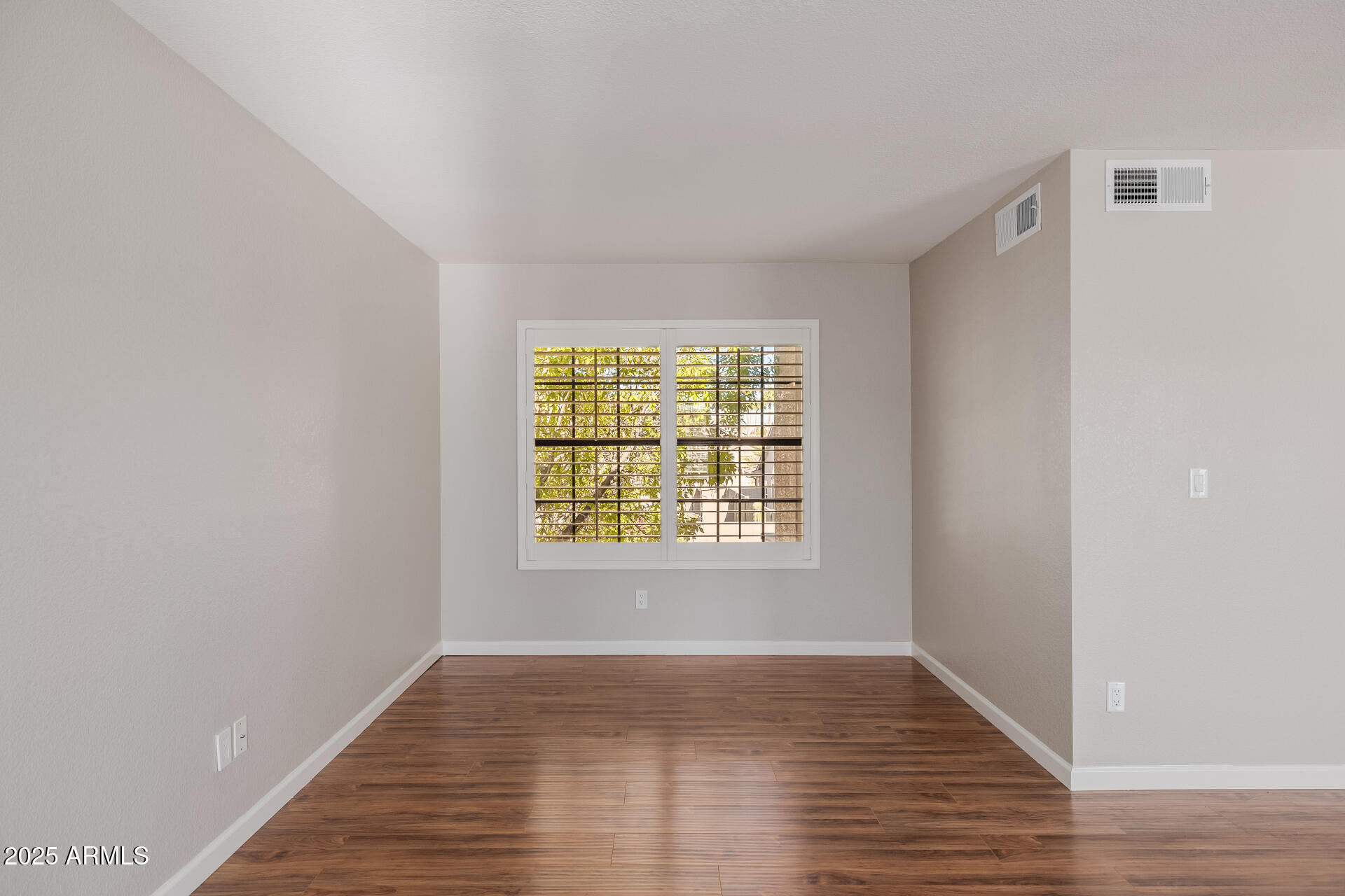 16809 South 33rd Way Phoenix, AZ 85048 - Photo 58 of 118 a view of an empty room with wooden floor and a window