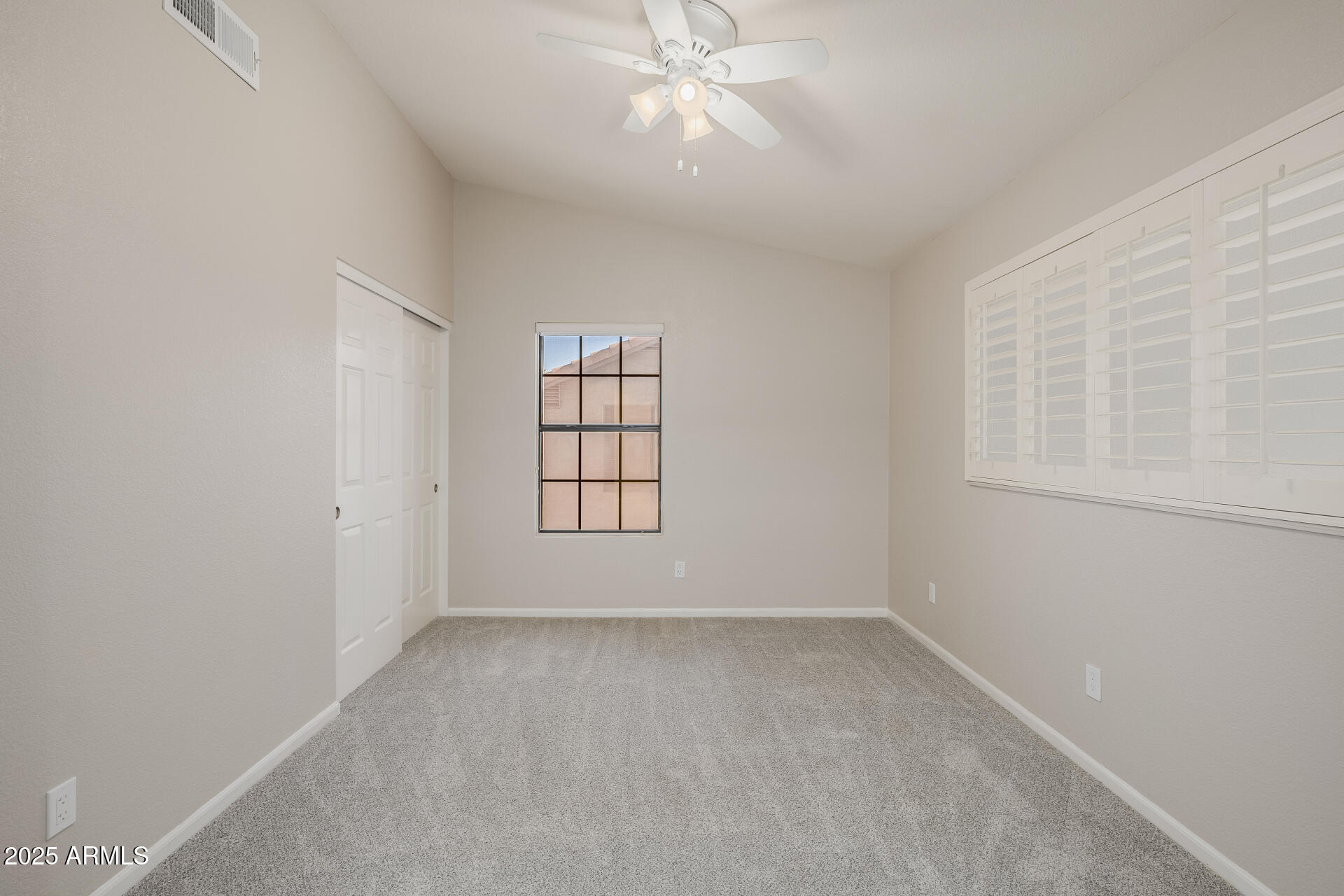 16809 South 33rd Way Phoenix, AZ 85048 - Photo 71 of 118 an empty room with a window and ceiling fan