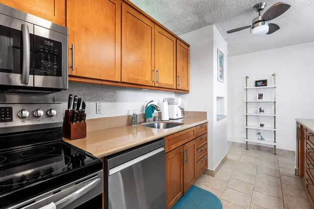 a kitchen with appliances cabinets and a sink