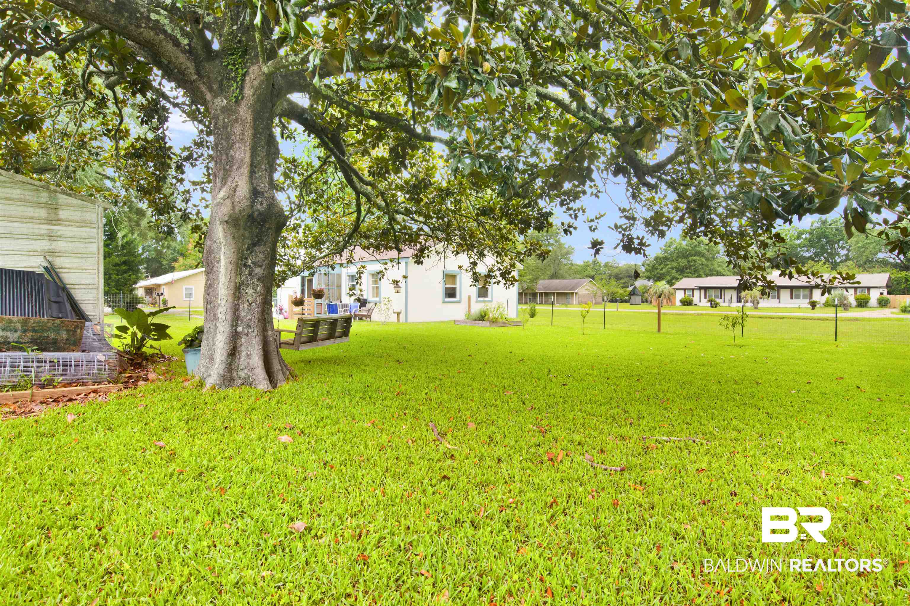 1100 North Pine Street Foley, AL 36535 - Photo 28 of 30 Expansive green lawn with a large mature tree providing natural shade