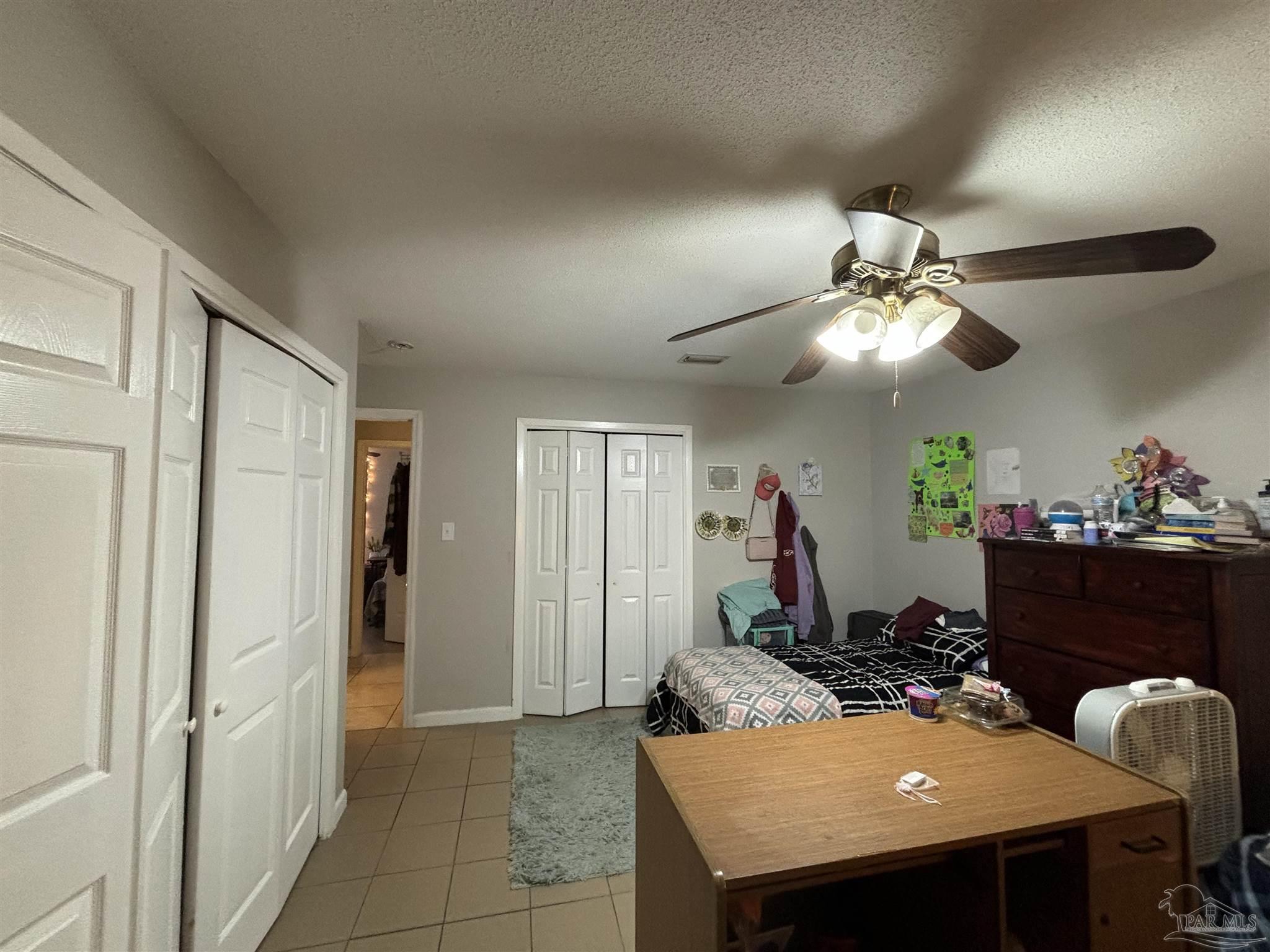 1080 Farmington Road Pensacola, FL 32504 - Photo 15 of 31 a view of a dining room with furniture and a chandelier fan