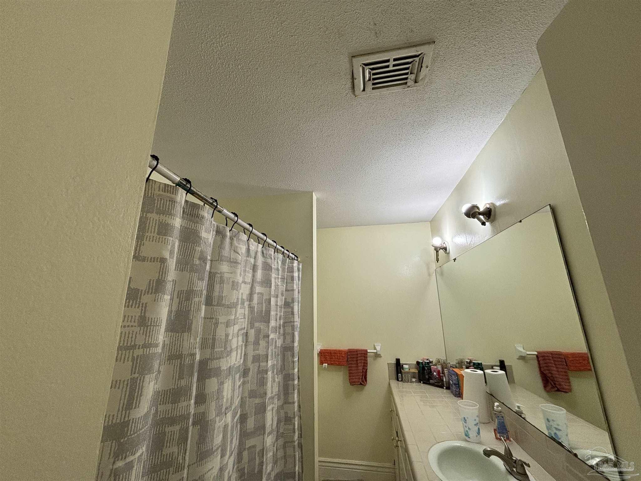 1080 Farmington Road Pensacola, FL 32504 - Photo 17 of 31 a bathroom with a shower and a sink