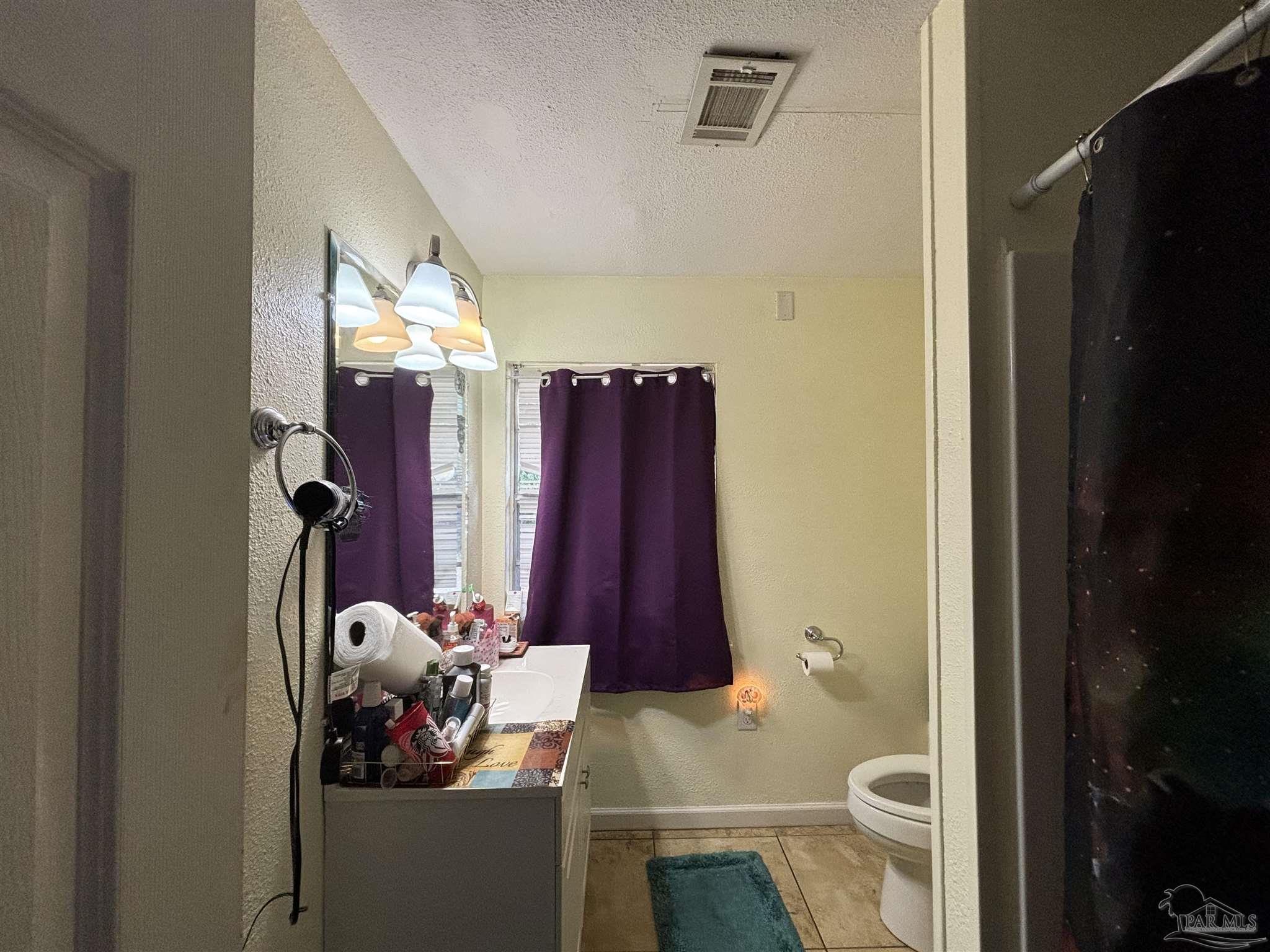 1080 Farmington Road Pensacola, FL 32504 - Photo 25 of 31 a bathroom with a toilet and a shower curtain