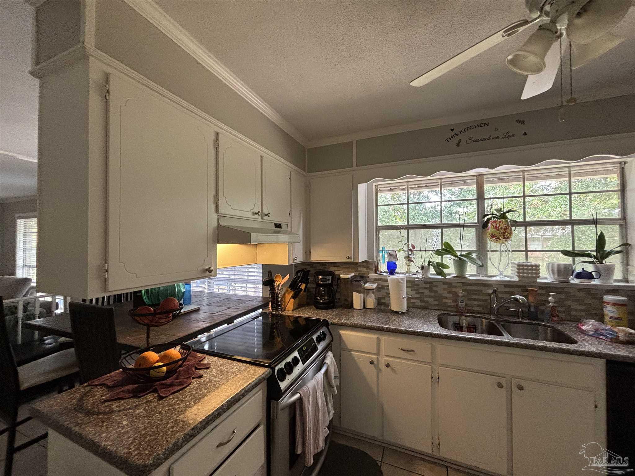 1080 Farmington Road Pensacola, FL 32504 - Photo 4 of 31 a kitchen with sink a stove and a window