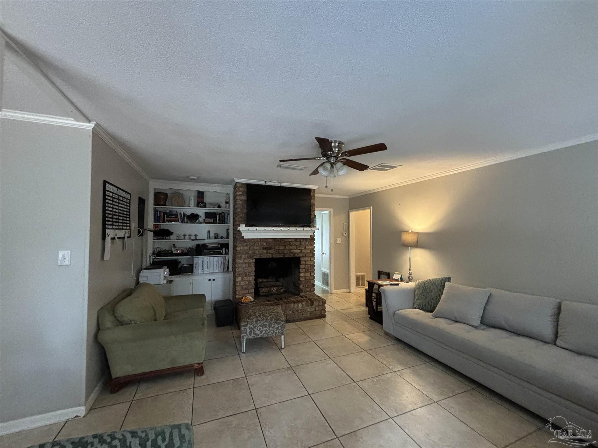 1080 Farmington Road Pensacola, FL 32504 - Photo 7 of 31 a living room with furniture and a fireplace