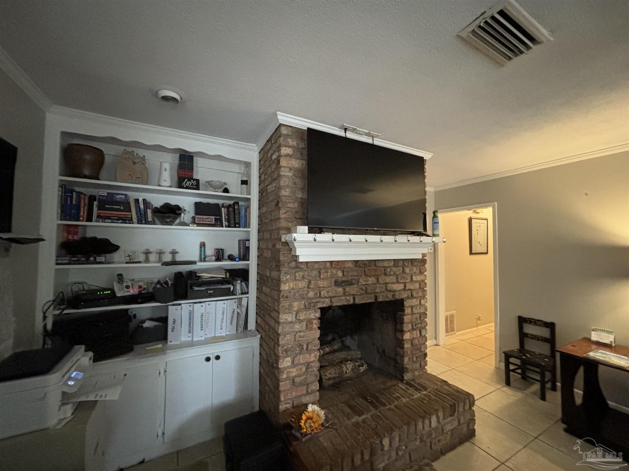 1080 Farmington Road Pensacola, FL 32504 - Photo 8 of 31 a living room with furniture a flat screen tv and a fireplace