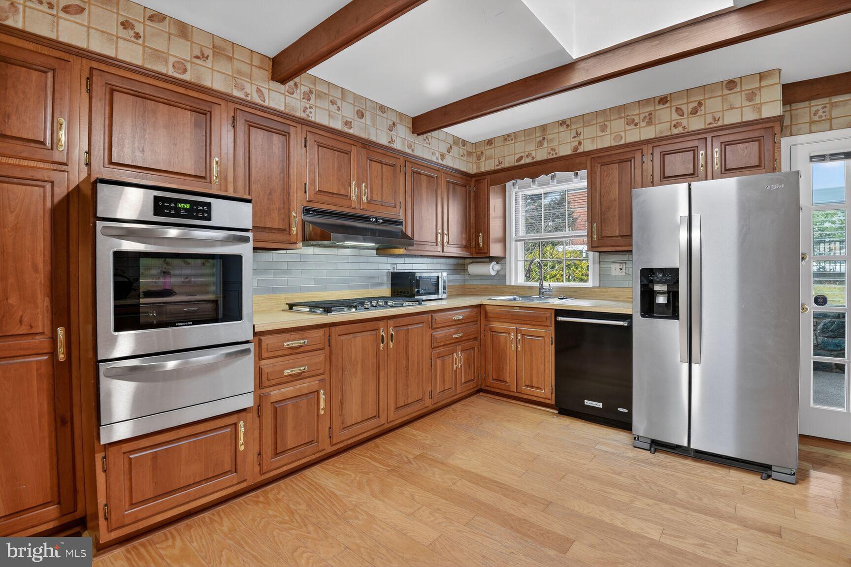 4709 River Road Bethesda, MD 20816 - Photo 11 of 25 a kitchen with granite countertop stainless steel appliances and refrigerator